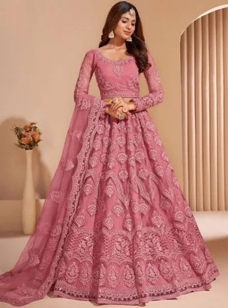 A woman wearing a Beautiful Lehenga with intricate ruffles and embellishments, showcasing elegant fashion design and haute couture elements.